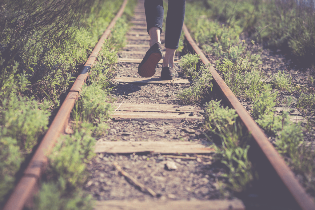 person walking down stone path