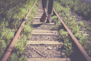 person walking down stone path