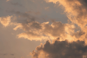 A sky of mixed clouds, some dark and some light, reflecting the emotional complexity of coming out later in life